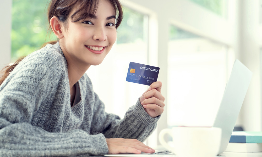 カフェでクレジットカードを持つ女性